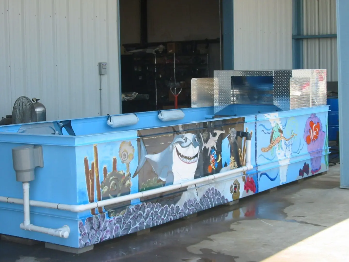 A blue and white ice chest with pictures of sea animals on it.